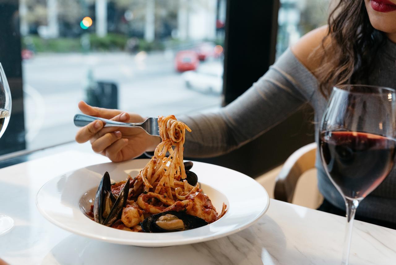 Art Series - The Chen Box Hill Exteriér fotografie A woman eating a pasta dish